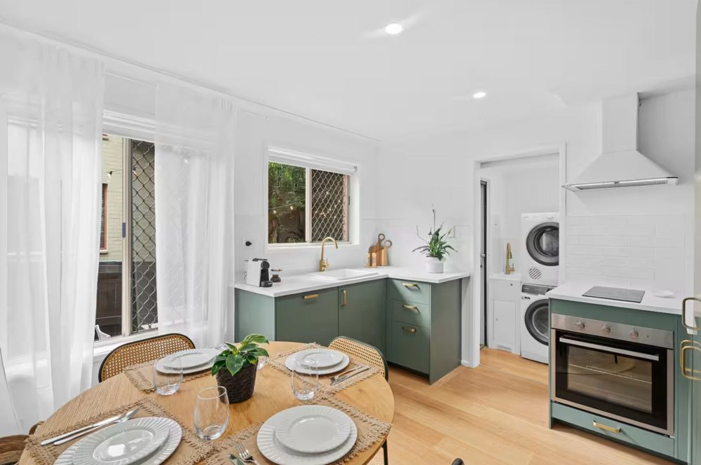 Renovated kitchen with dining table and laundry