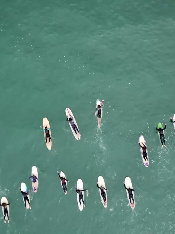 Surfers lined up waiting for waves